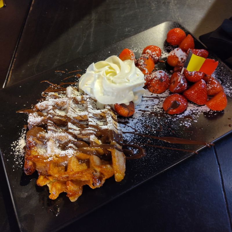 Waffle. Chocolate. Strawberries. Icing sugar. Cream. And a flag. That’ll do it.